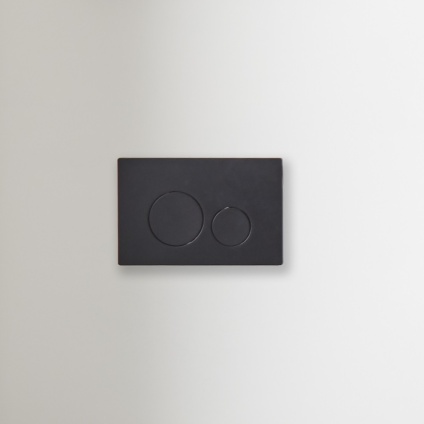 product lifestyle image of Roper Rhodes Rondo Black Dual Flush Push Plate on white wall TR9021